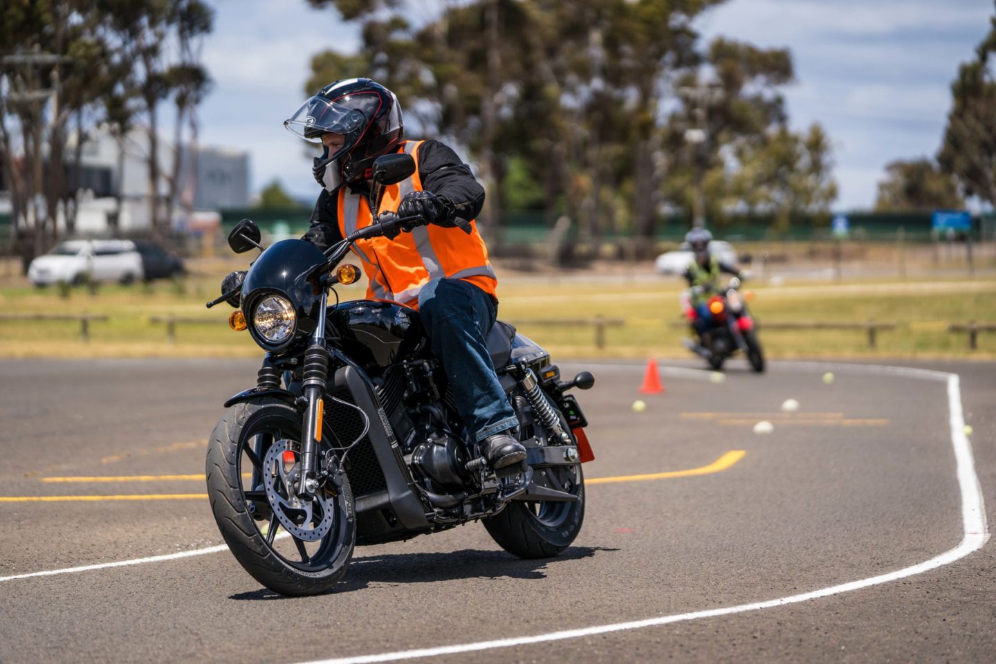 Motorcycle rider with vest training on corners